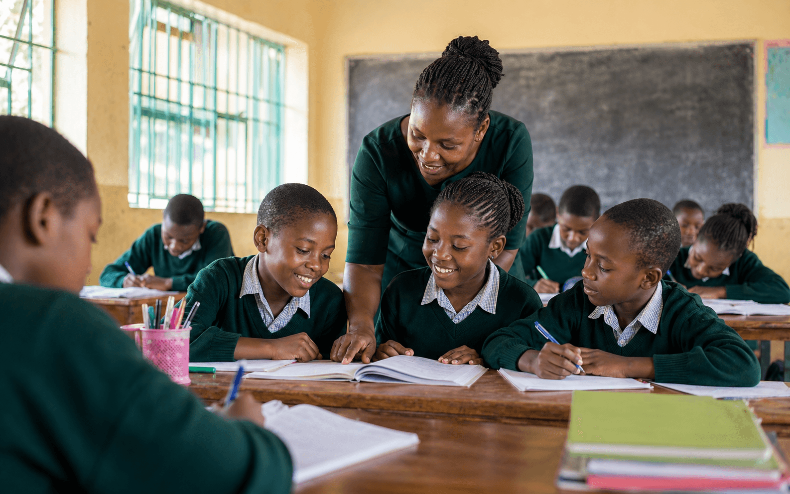 Learners and a teacher engaged in class at Gacharage Primary.